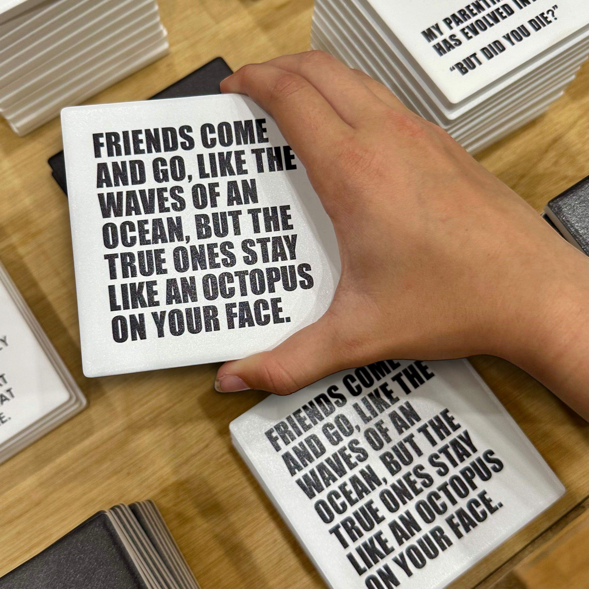 Let's Be Frank Australia square ceramic coaster with black typography quote about octopus friends on a white background
